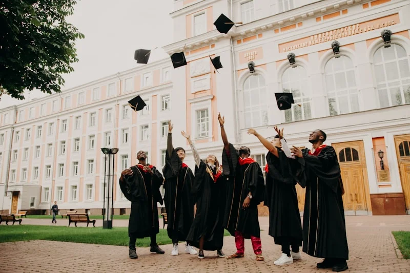 Graduates celebrating together and throwing their caps